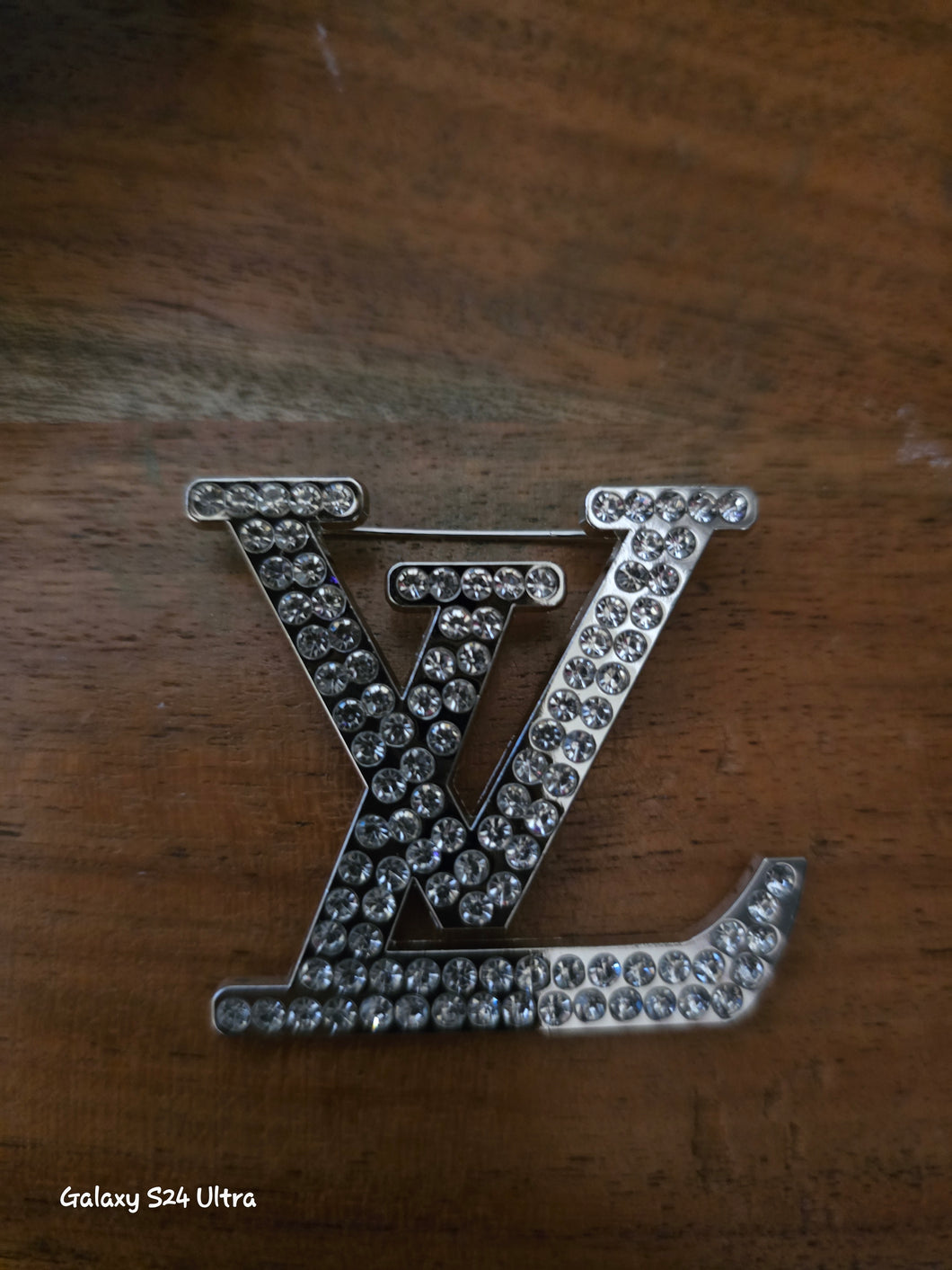 LV silver tone brooch