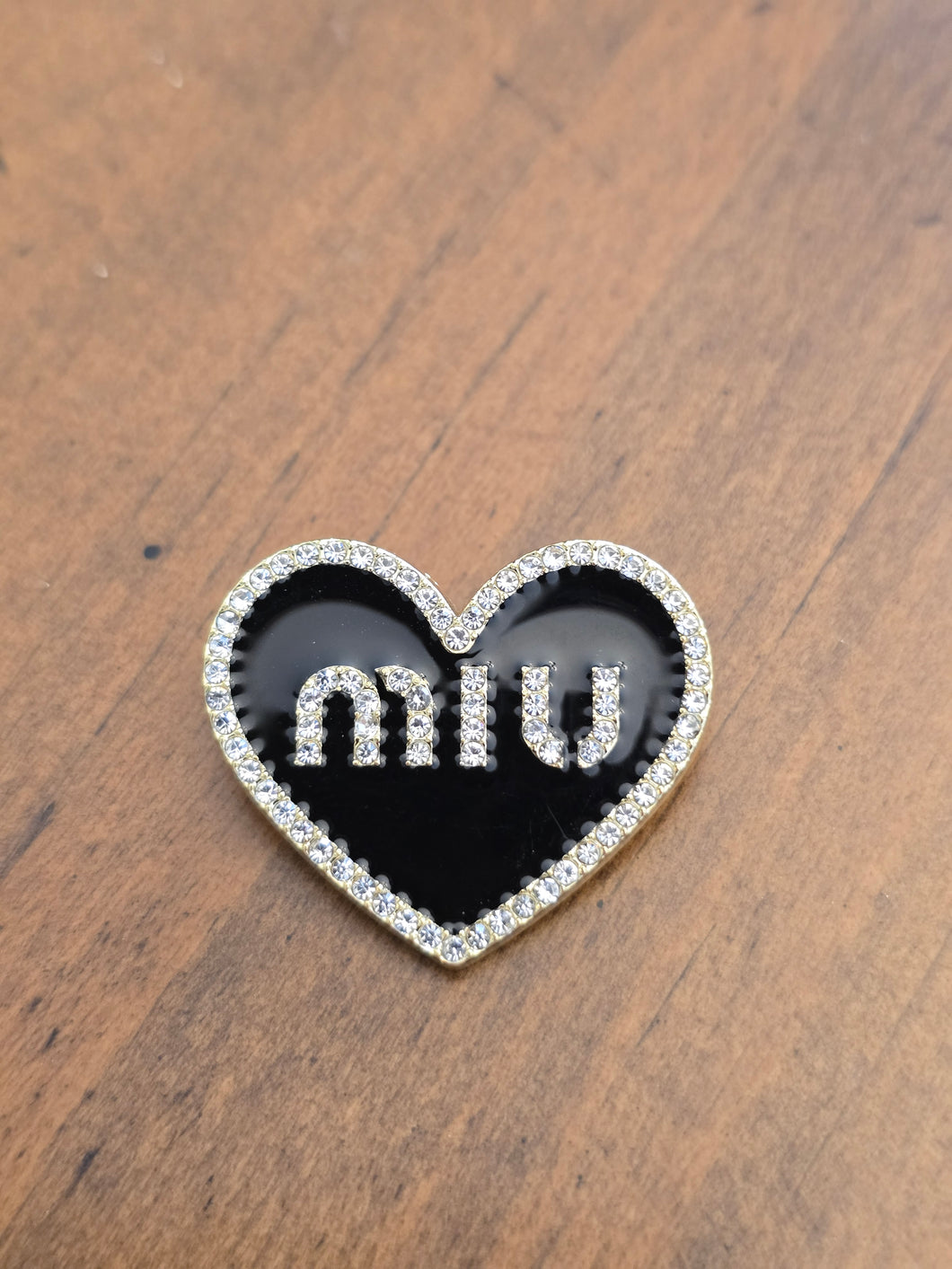 MIU brooch