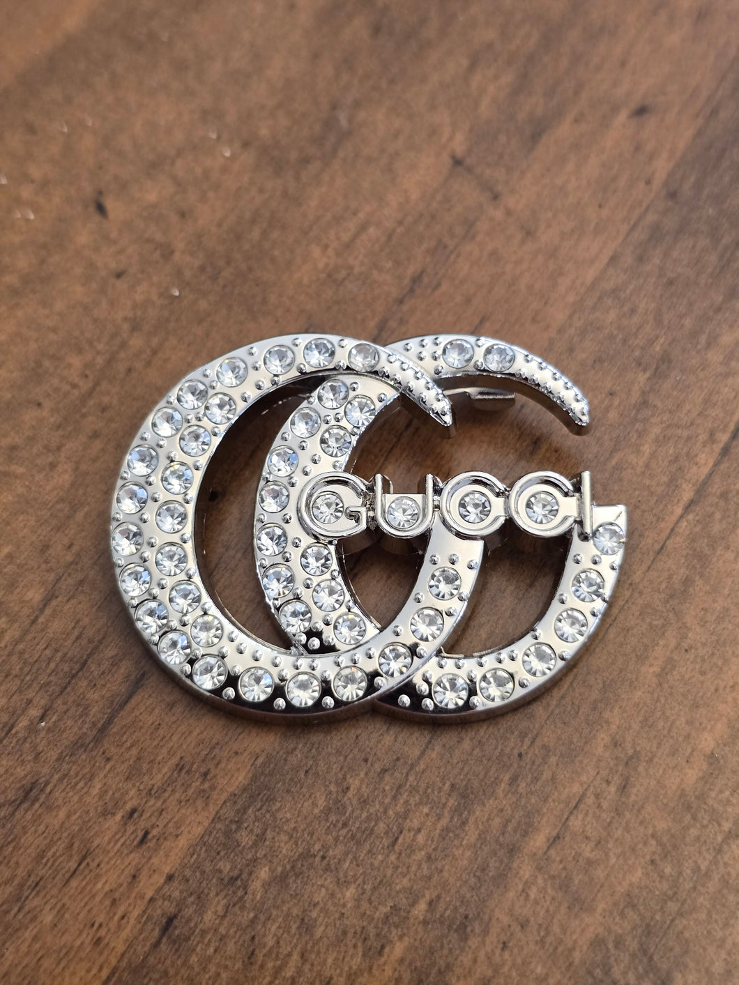 Gucci brooch . .